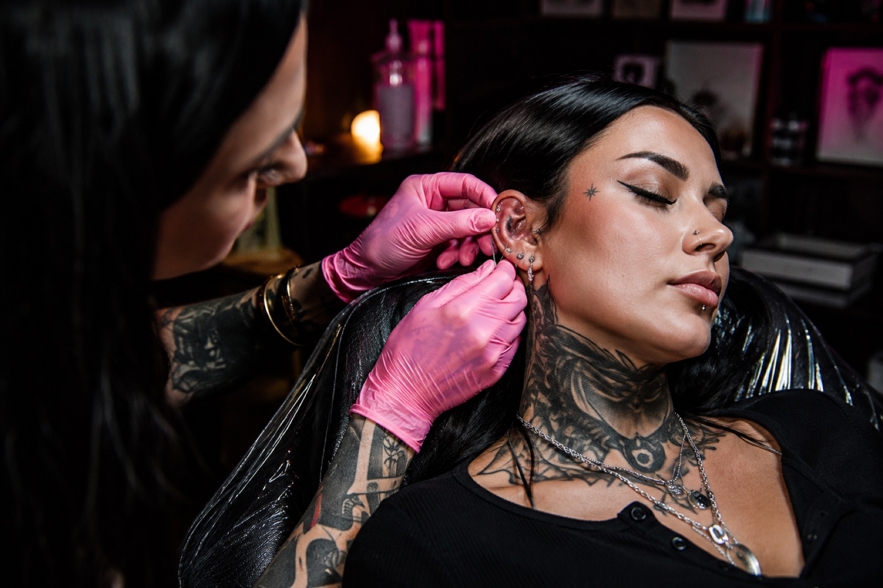 A close-up of an ear piercing being performed in the studio.