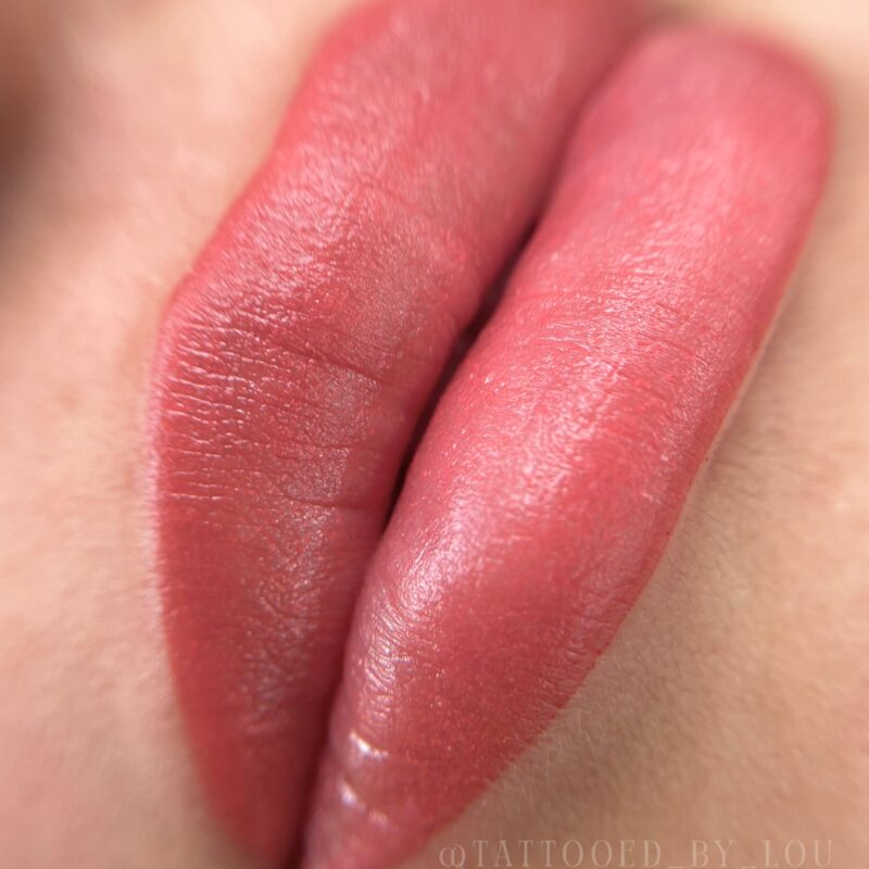 Close-up of lips after a lip blush permanent makeup session by Lindsey, in a soft rosy tone.
