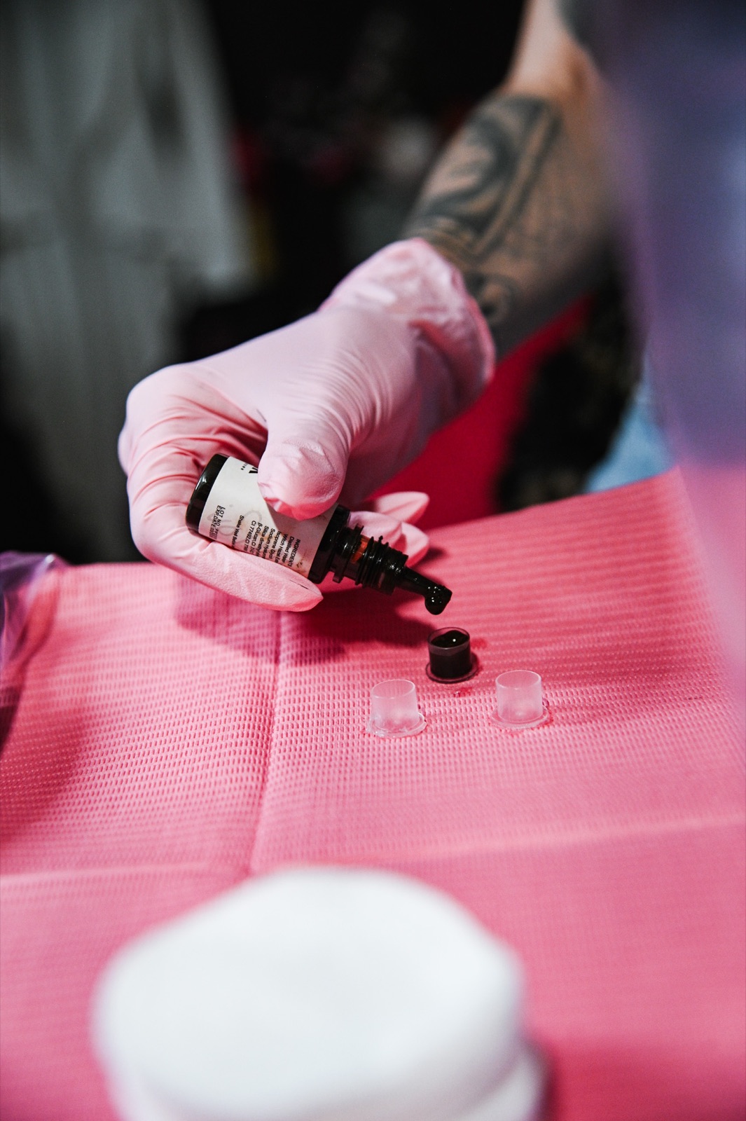 Lindsey pouring permanent makeup pigment during a treatment at The Fine Line.